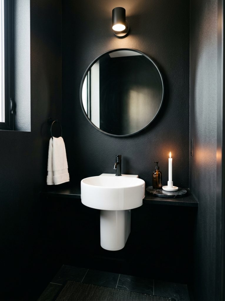  Black aesthetic half bathroom with matte black walls black mirror white sink marble tray and white candle